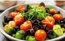 Fresh salad bowl with microgreens, tomatoes and olives