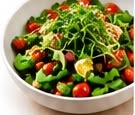 Salad bowl topped with broccoli microgreens