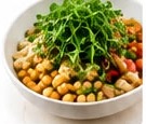 Chickpea chaat bowl topped with microgreens