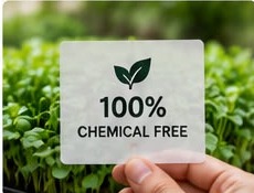 A 100% chemical free label held over microgreens